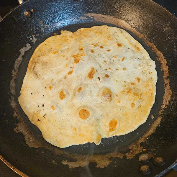 Step 2: tortilla cooking on the griddle